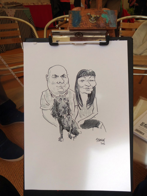caricature drawing on artist's easel of guests with dog, malpas, cheshire garden party