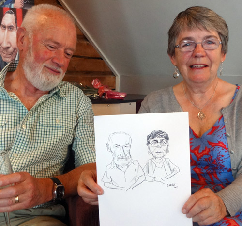 guests with drawing by caricaturist, stratford upon avon, warwickshire